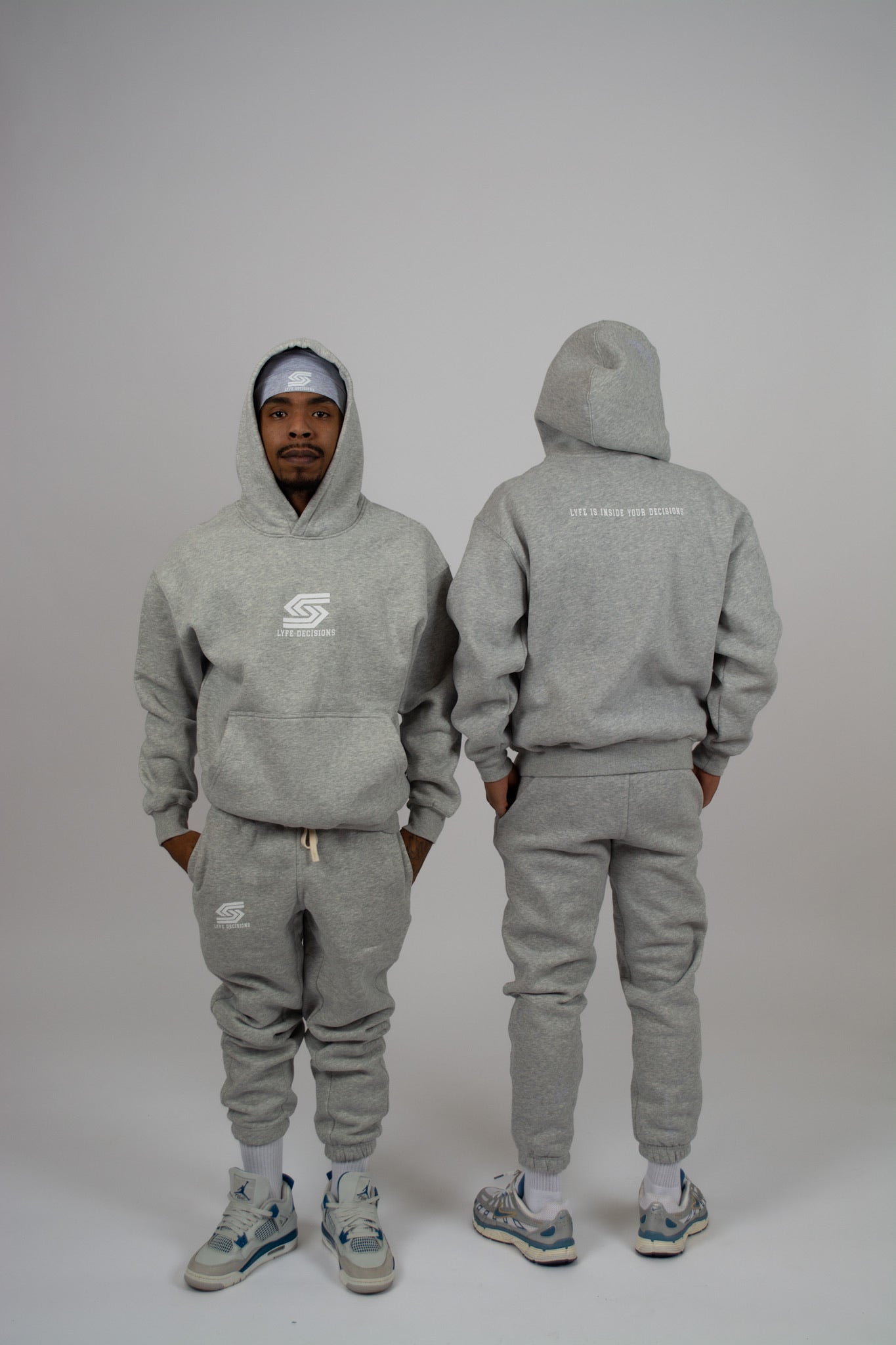Man wearing grey LYFE Set hoodie and pants - full outfit front view